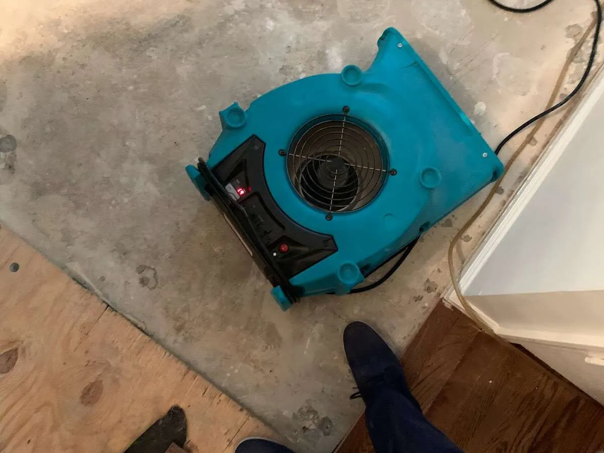 Air mover drying subfloor during Leak Detection & Repair in Zion